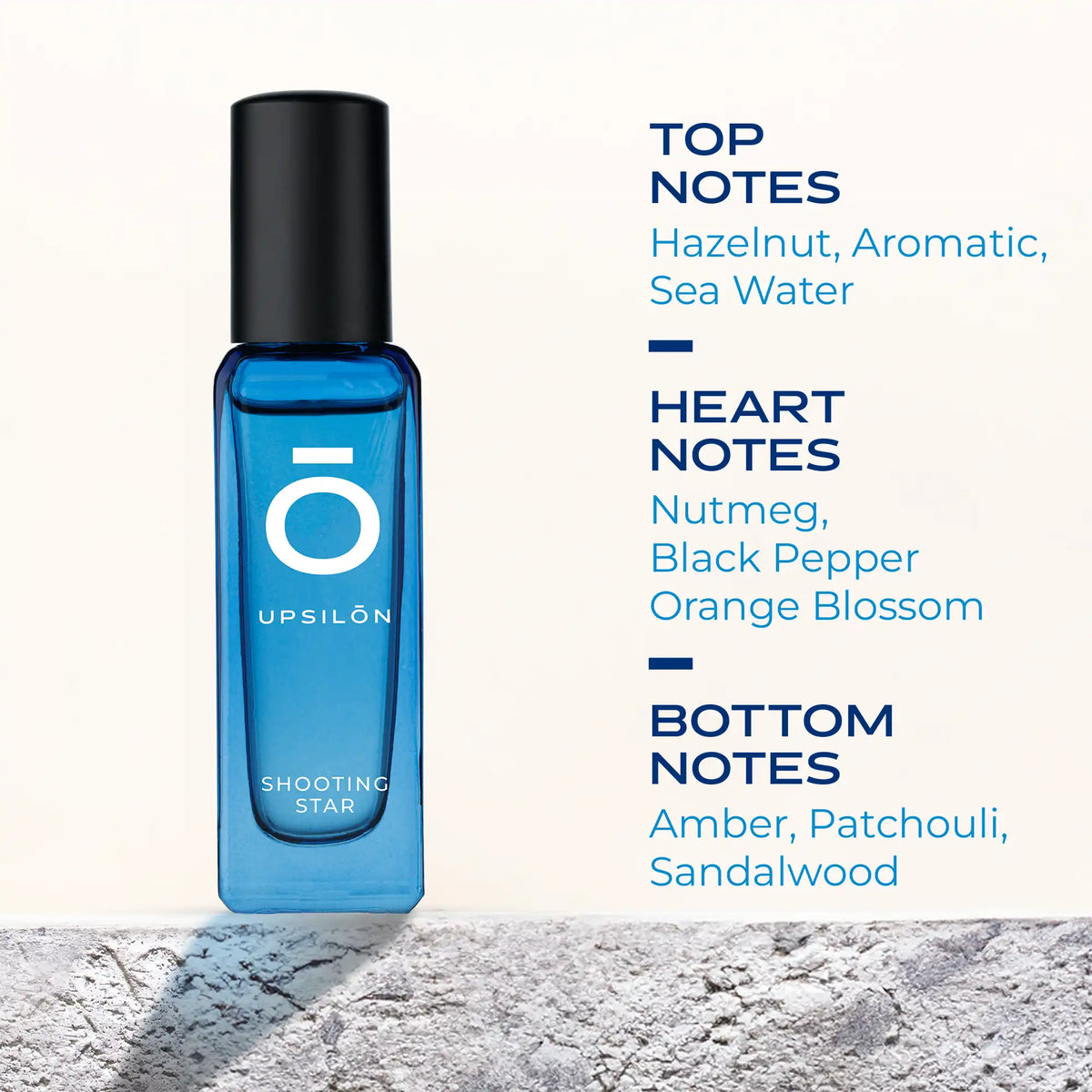 A sleek black bottle of UPSILON Shooting Star Eau de Parfum, a premium men's fragrance with top notes of hazelnut, aromatic, and sea water, heart notes of nutmeg, black pepper, and orange blossom, and base notes of amber, patchouli, and sandalwood