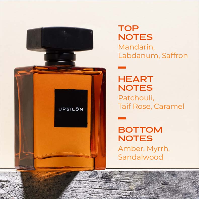 A bottle of Upsilon Golden Sand Eau de Parfum, a premium long-lasting fresh and powerful fragrance spray for men. The fragrance features top notes of mandarin, labdanum, and saffron, heart notes of patchouli, Taif rose, and caramel, and base notes of amber, myrrh, and sandalwood
