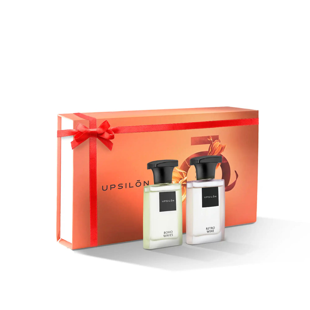 A festive gift box tied with a red ribbon, containing two bottles of Upsilon Eau de Parfum in travel sizes, perfect for gifting or self-indulgence