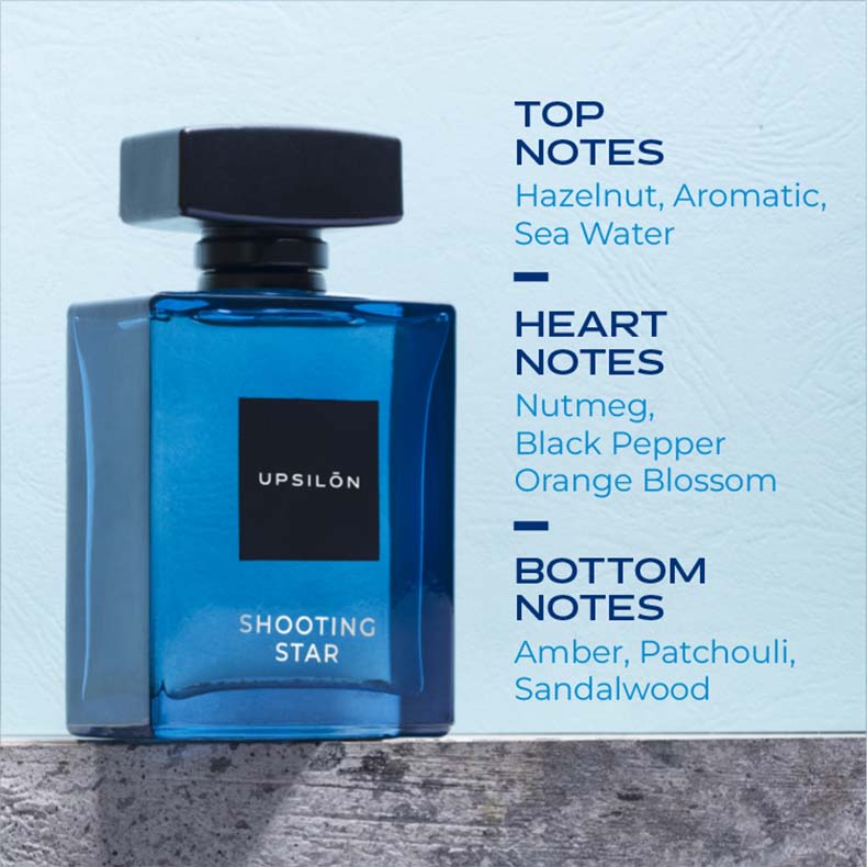 A sleek black bottle of UPSILON Shooting Star Eau de Parfum, a premium men's fragrance with top notes of hazelnut, aromatic, and sea water, heart notes of nutmeg, black pepper, and orange blossom, and base notes of amber, patchouli, and sandalwood